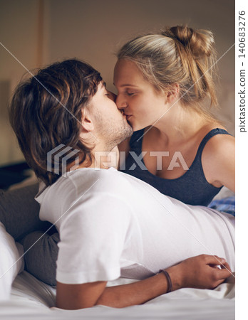 Love, kiss and couple on a bed with care, trust and support, security and bonding in their home together. Morning, romance and people embrace in a bedroom with intimacy, moment or fun in their house Love, kiss and couple on a bed with care, trust and support, security and bonding in their home together. Morning, romance and people embrace in a bedroom with intimacy, moment or fun in their house 140683276