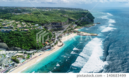 Aerial view of tropical turquoise beach, rocky cliffs and ocean waves 140683499