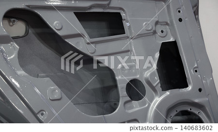 Car door metal sheet. Close up automotive door inner panels and stamped steel body parts. Modern vehicle manufacturing facility. Precision metal forming. Metal Car doors automotive assembly technology Car door metal sheet. Close up automotive door inner panels and stamped steel body parts. Modern vehicle manufacturing facility. Precision metal forming. Metal Car doors automotive assembly technology 140683602