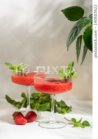 Two strawberry cocktails garnished with fresh mint for summer Two strawberry cocktails garnished with fresh mint for summer 140683622