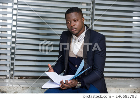 portrait of a young businessman with document. portrait of a young businessman with document. 140683798