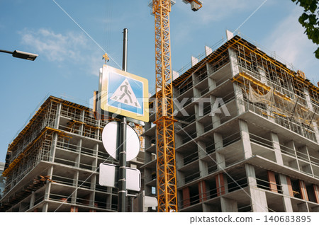 High rise building under construction with tower crane High rise building under construction with tower crane 140683895