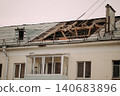 Roof renovation site with concrete slabs and construction materials near residential building 140683896