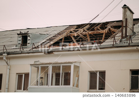 Roof renovation site with concrete slabs and construction materials near residential building 140683896