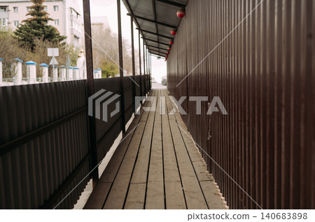 Temporary pedestrian walkway along construction site Temporary pedestrian walkway along construction site 140683898