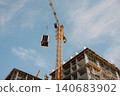 High rise building under construction with tower crane 140683902