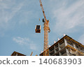 High rise building under construction with tower crane 140683903