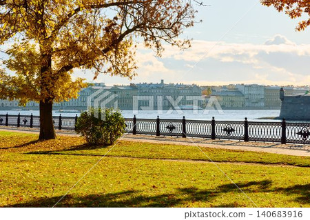 Isaac cathedral, Winter Palace, picturesque metal railings with a double-headed eagle and the crown of the Russian Empire on embankment in St. Petersburg, autumn sunset, incredible sun glare, Russia Isaac cathedral, Winter Palace, picturesque metal railings with a double-headed eagle and the crown of the Russian Empire on embankment in St. Petersburg, autumn sunset, incredible sun glare, Russia 140683916