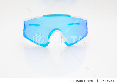 stylish sunglasses on a glossy white table, blue glass, white sunglasses frame, yachting glasses, cycling glasses, reflection on a glossy surface stylish sunglasses on a glossy white table, blue glass, white sunglasses frame, yachting glasses, cycling glasses, reflection on a glossy surface 140683933