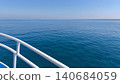 Calm blue sea stretching to the horizon viewed from a boat deck. Peaceful maritime landscape symbolizing travel, freedom, relaxation and summer vacation. 140684059