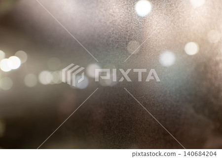 Beautiful city lights and a bokeh texture background, seen through frosted glass. Beautiful city lights and a bokeh texture background, seen through frosted glass. 140684204