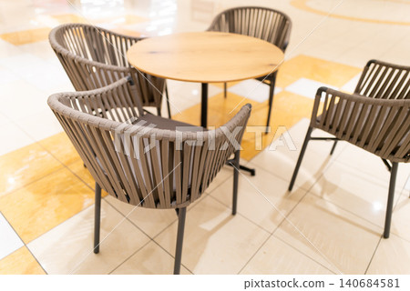 Bright cafe tables and chairs inside a commercial facility Bright cafe tables and chairs inside a commercial facility 140684581