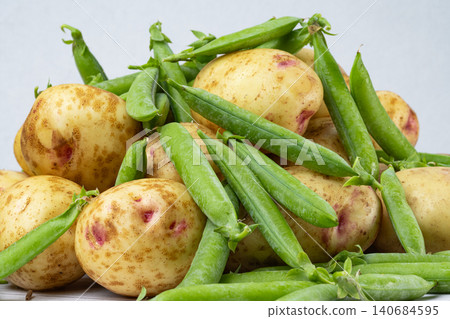 potatoes with peas and zucchini potatoes with peas and zucchini 140684595