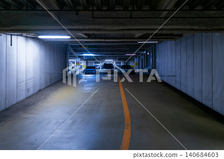 A stylish indoor parking garage location illuminated by fluorescent lights. A stylish indoor parking garage location illuminated by fluorescent lights. 140684603