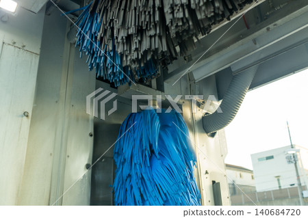 A scene of a car being washed by an automatic car wash machine at a gas station. A scene of a car being washed by an automatic car wash machine at a gas station. 140684720