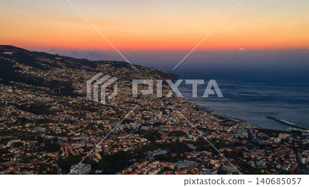 Aerial dusk view of Funchal, Madeira harbor and terraced hillsides 140685057