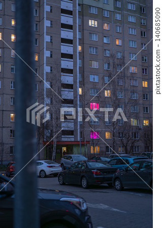 Dusk view of khrushchyovka facade in Minsk with magenta windows Dusk view of khrushchyovka facade in Minsk with magenta windows 140685090