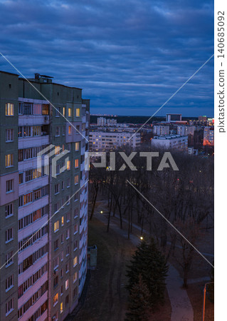 Dusk Minsk cityscape with Khrushchyovka block and lamplit park path Dusk Minsk cityscape with Khrushchyovka block and lamplit park path 140685092