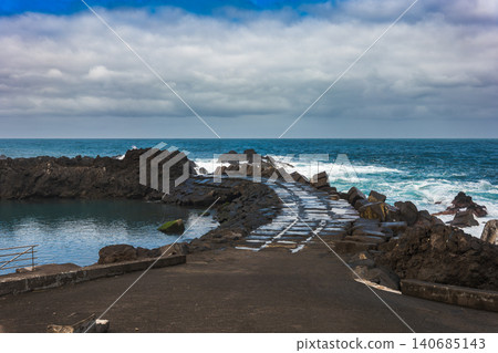 Basalt seawall and tetrapods at lava pools in Porto Moniz, Madeira Basalt seawall and tetrapods at lava pools in Porto Moniz, Madeira 140685143