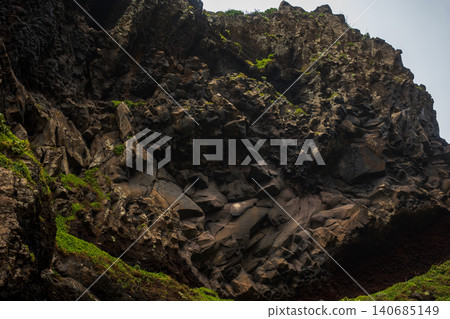 Rugged basalt cliff with moss and columnar lava forms in Madeira Rugged basalt cliff with moss and columnar lava forms in Madeira 140685149