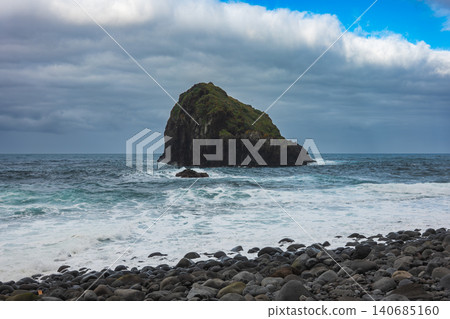 Basalt sea stack off Madeira north shore from rocky pebble beach Basalt sea stack off Madeira north shore from rocky pebble beach 140685160
