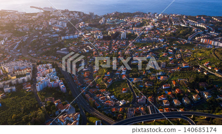 Aerial view of Funchal Madeira hillside city and Atlantic harbor 140685174
