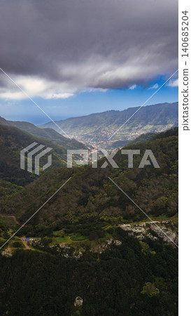 Aerial valley view in Madeira with town, storm clouds, and Atlantic 140685204