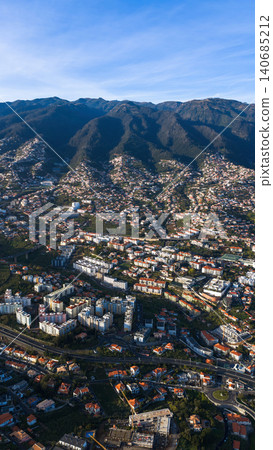 Funchal hillside city on Madeira with red roofs and mountain backdrop 140685212