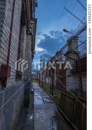 Lukiskes Prison corridor toward Vilnius office towers at twilight Lukiskes Prison corridor toward Vilnius office towers at twilight 140685253
