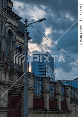 Lukiskes Prison facade and modern glass tower in Vilnius at dusk Lukiskes Prison facade and modern glass tower in Vilnius at dusk 140685261