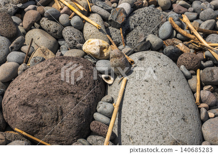 Madeira pebble beach with basalt rocks, driftwood, and Atlantic polish 140685283