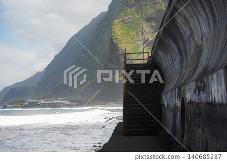 Curving seawall and stairs on Madeira north coast near Seixal Curving seawall and stairs on Madeira north coast near Seixal 140685287
