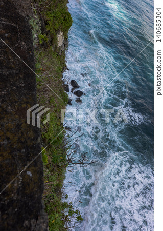 Atlantic surf crashes below basalt cliff on Madeira coastline 140685304