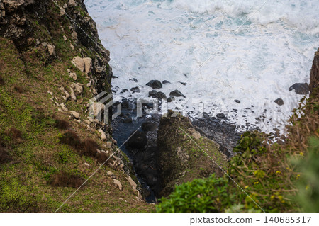 Cliff and rocky cove on Madeira as Atlantic surf meets volcanic rock Cliff and rocky cove on Madeira as Atlantic surf meets volcanic rock 140685317