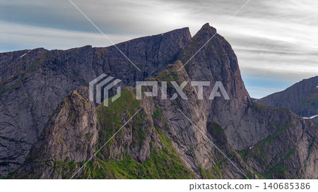 Dramatic Rocky Mountain Peaks Lofoten Panorama with Alpine Vegetation Dramatic Rocky Mountain Peaks Lofoten Panorama with Alpine Vegetation 140685386