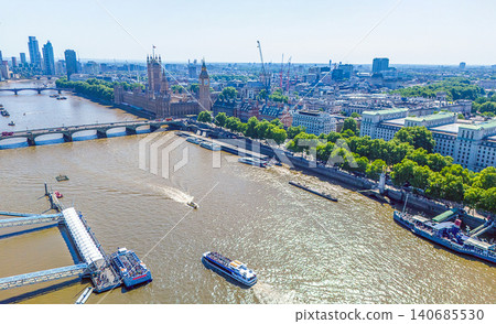 Panorama in downtown include distant Ferris wheel, Thames river with pleasure boats and Big Ben tower Panorama in downtown include distant Ferris wheel, Thames river with pleasure boats and Big Ben tower 140685530
