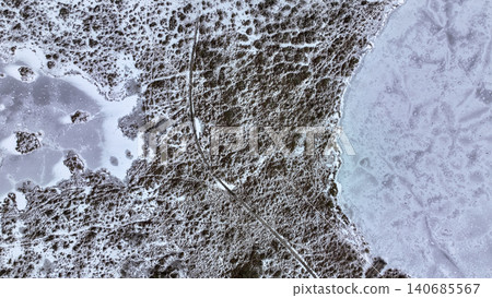 Aerial View of Snowy Landscape with Frozen Lake and Central Path Aerial View of Snowy Landscape with Frozen Lake and Central Path 140685567