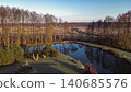 Reflective Pond with Leafless Trees in a Rural Landscape 140685576
