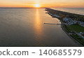 Sunset Over a Lake with Pier and Forested Shoreline 140685579