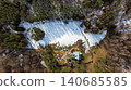 Aerial View of Snow Covered Forest and Rural Property 140685585