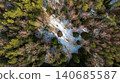 Aerial View of Snow Covered Forest Clearing with Central Boulder 140685587