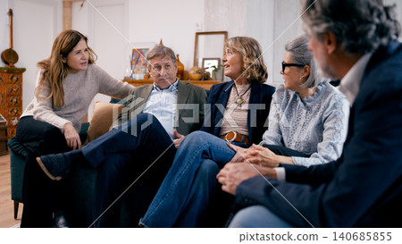 Seniors friends gathering discussing enjoying conversation at home Seniors friends gathering discussing enjoying conversation at home 140685855
