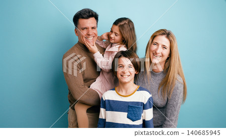 Happy family with parents and children smiling together Happy family with parents and children smiling together 140685945