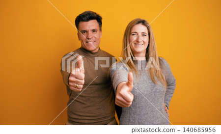 Happy couple giving thumbs up in agreement 140685956