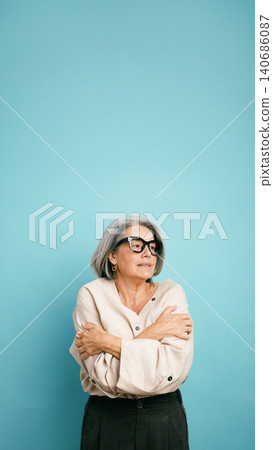Senior woman feeling cold hugging herself with crossed arms Senior woman feeling cold hugging herself with crossed arms 140686087