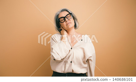 Mature woman having neck pain feeling discomfort 140686101