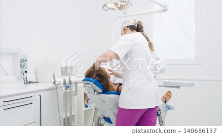 Dentist examining patient in modern dental clinic Dentist examining patient in modern dental clinic 140686137