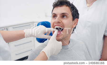 Man receiving dental care with dental appliance Man receiving dental care with dental appliance 140686166
