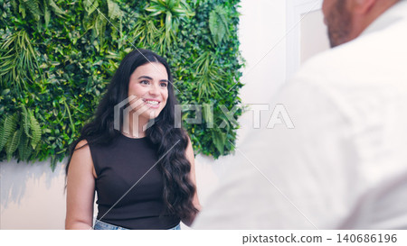 Woman smiling while talking with dentist during consultation Woman smiling while talking with dentist during consultation 140686196
