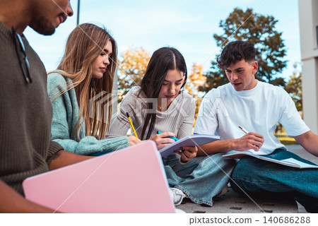 College students collaborating on school project outdoors College students collaborating on school project outdoors 140686288